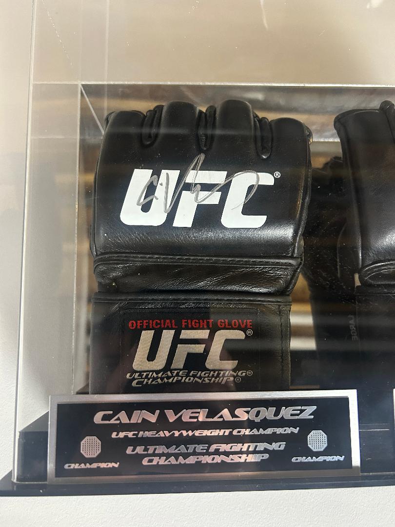 Cain Velasquez and Junior Dos Santos Signed Gloves